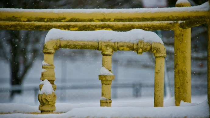a yellow fire hydrant covered in snow